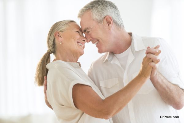 Romantic senior couple dancing at home