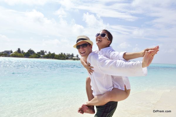 happy young couple have fun on beach