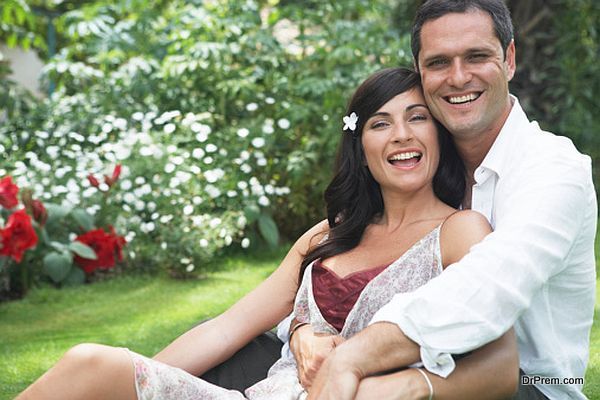 Couple embracing in garden, smiling, portrait, close-up