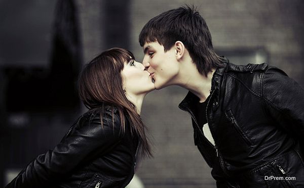 Happy young couple kissing on the city street