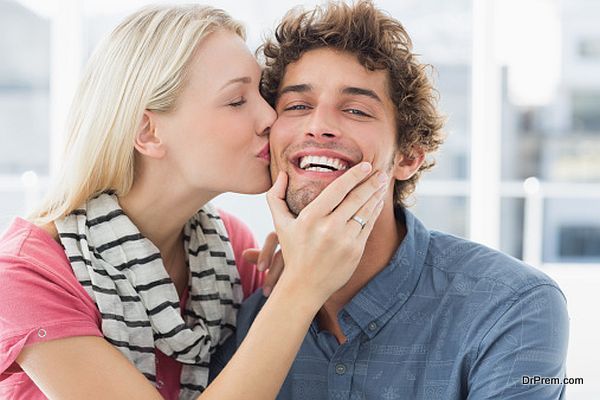 Woman kissing man on his cheek