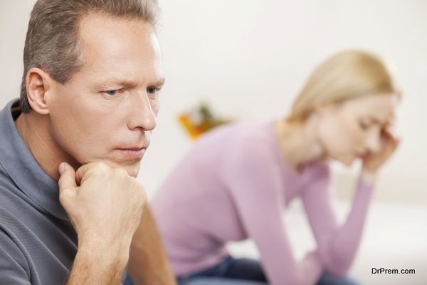 Depressed couple. Side view of depressed mature man holding hand