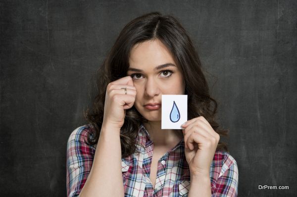 Young Woman Holding Paper With Tears Drawn On It