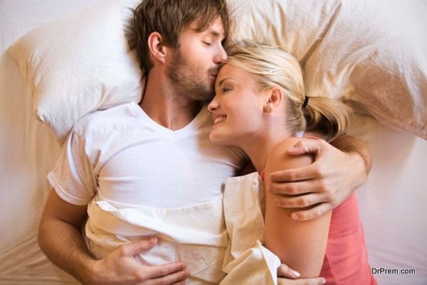 Couple cuddling in bed