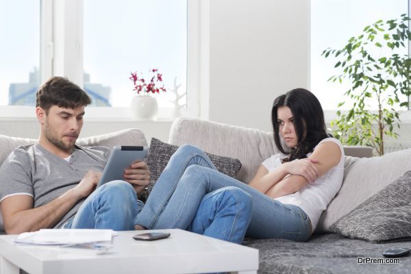 young couple in conflict, a guy with a tablet