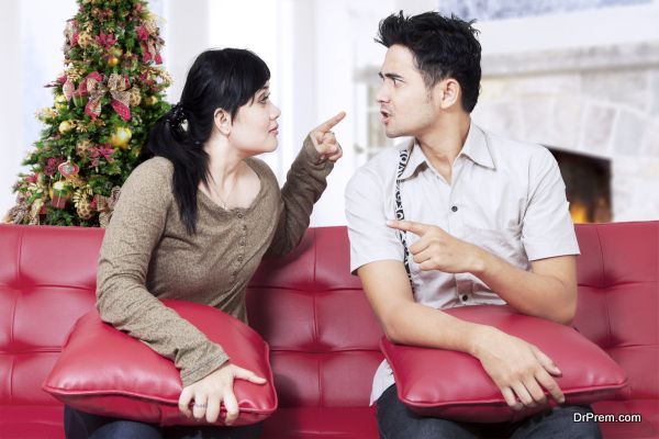Couple quarreling on sofa in christmas day