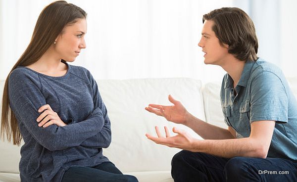 Man Explaining Woman While Arguing In Living Room