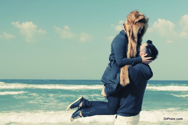 Beautiful young couple relaxing outdoor at winter beach
