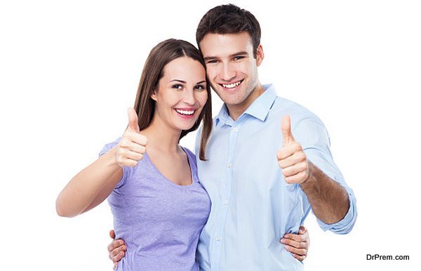 Young couple with thumbs up